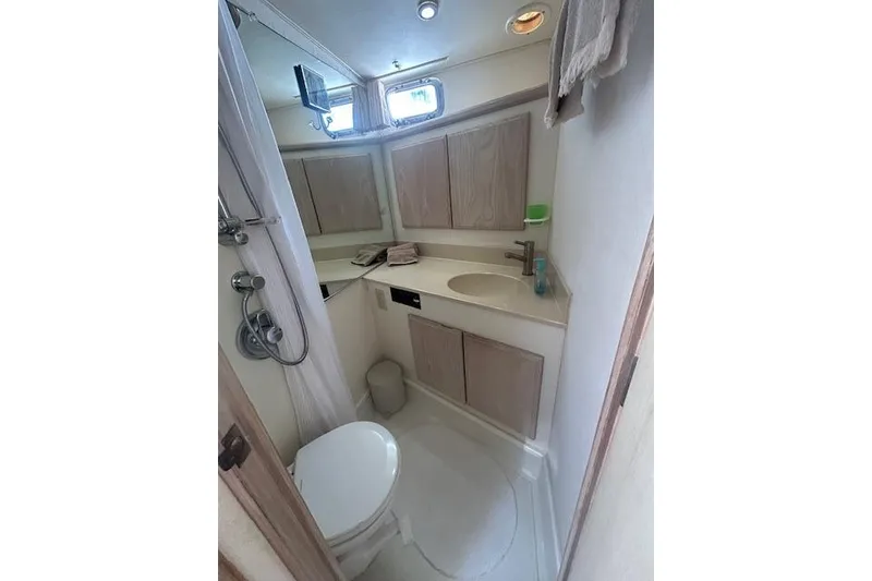 Slide: The Image of Bathroom interior of 1994 Tollycraft 45 Cockpit Motor Yacht, featuring shower and sink. - 37