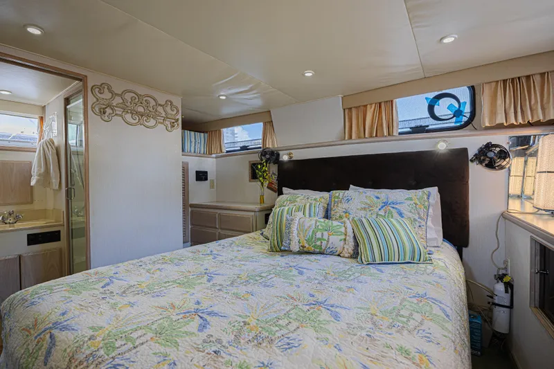 Slide: The Image of Luxurious bedroom interior of 1994 Tollycraft 45 Cockpit Motor Yacht with floral bedding. - 38
