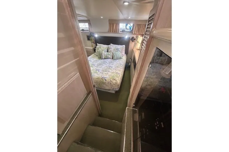 Slide: The Image of Cozy bedroom in 1994 Tollycraft 45 Cockpit Motor Yacht with floral bedding. - 39