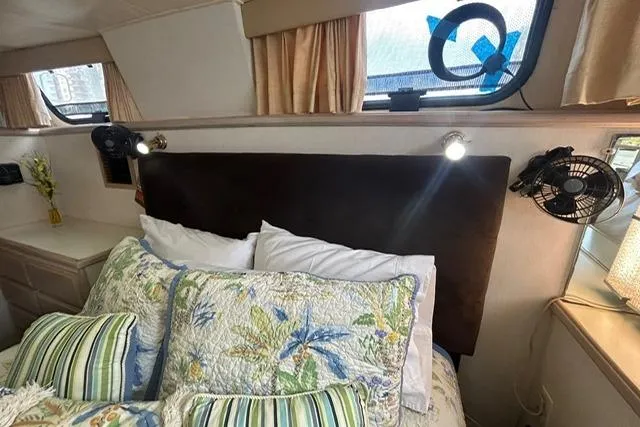 Slide: The Image of Interior of 1994 Tollycraft 45 Cockpit Motor Yacht with floral bedding and reading lights. - 41