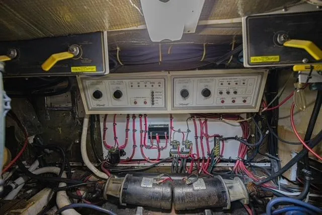 Slide: The Image of Engine room of 1994 Tollycraft 45 Cockpit Motor Yacht with control panels and wiring. - 43