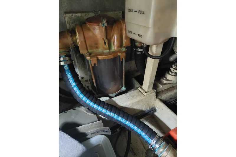 Slide: The Image of Engine compartment of 1993 Tollycraft 45 Cockpit Motor Yacht, featuring hoses and components. - 44