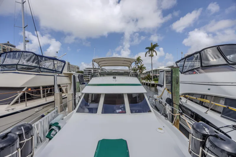 Slide: The Image of 1994 Tollycraft 45 Cockpit Motor Yacht docked at marina under blue sky. - 52