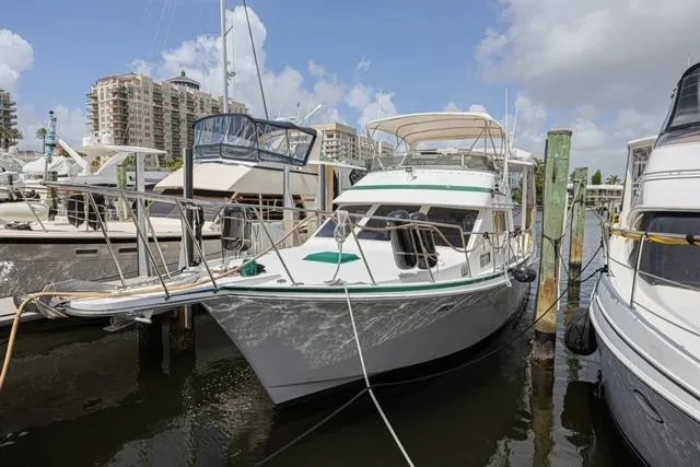 Slide: The Image of 1994 Tollycraft 45 Cockpit Motor Yacht docked at marina under blue sky. - 55