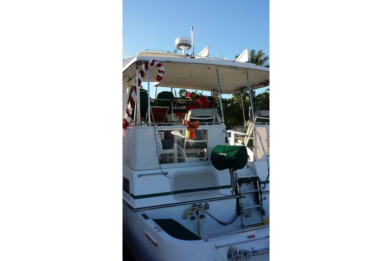 Slide: The Image of 1993 Tollycraft 45 Cockpit Motor Yacht decorated with festive garlands and greenery. - 6