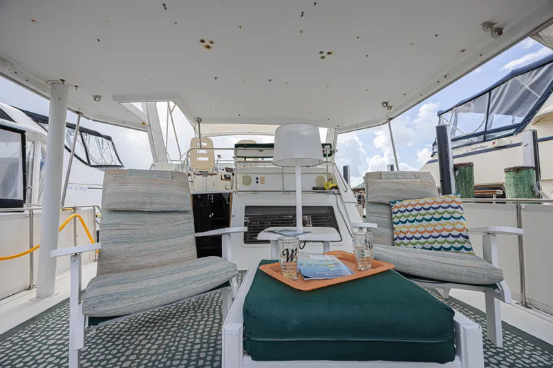 Slide: The Image of 1994 Tollycraft 45 Cockpit Motor Yacht interior with cozy seating and nautical decor. - 9