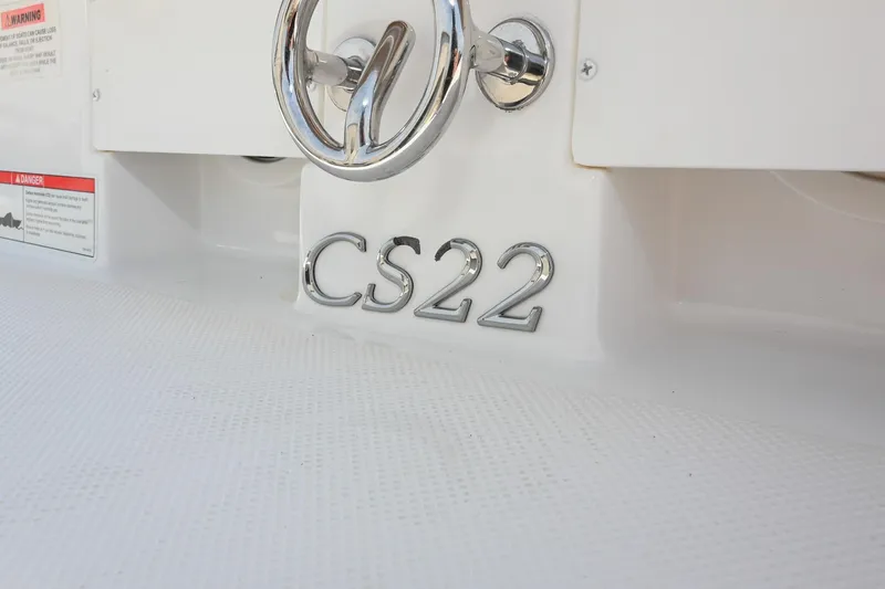 Slide: The Image of 2022 Cobalt CS22 boat emblem on white surface with chrome detailing. - 10