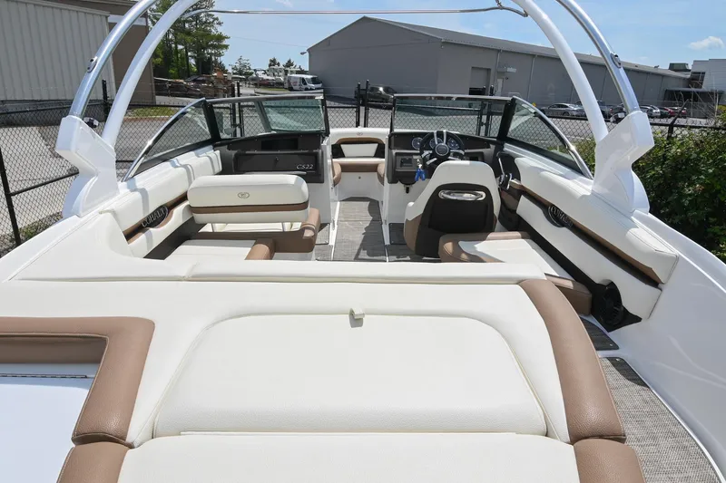 Slide: The Image of 2022 Cobalt CS22 boat interior with white and brown seating, steering wheel, and dashboard. - 12