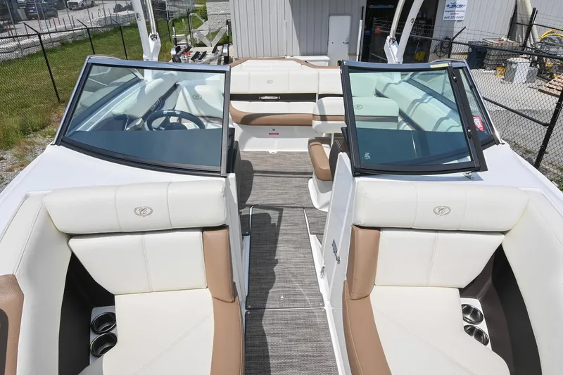 Slide: The Image of 2022 Cobalt CS22 boat interior with white and brown seating, open windshield, and steering wheel. - 13