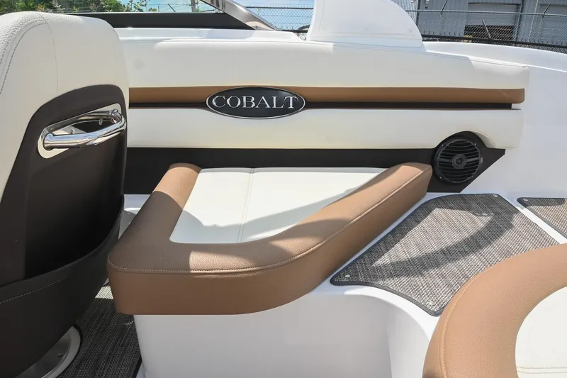 Slide: The Image of 2022 Cobalt CS22 boat interior with beige and white seating, featuring sleek design elements. - 20