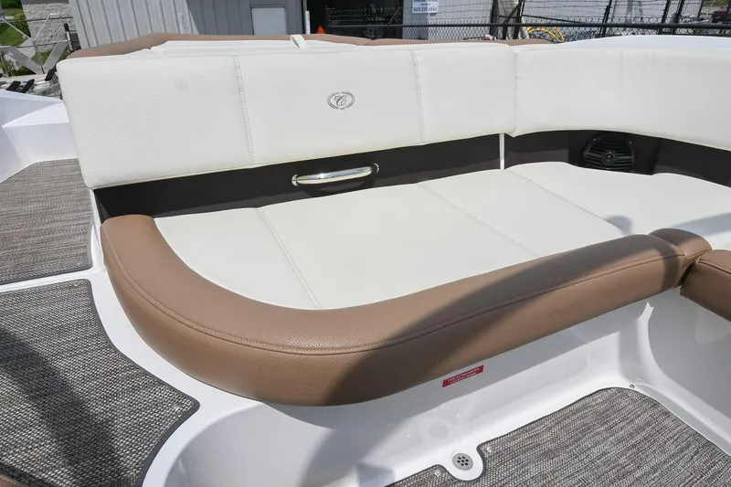 Slide: The Image of 2022 Cobalt CS22 boat interior with white and brown cushioned seating. - 21