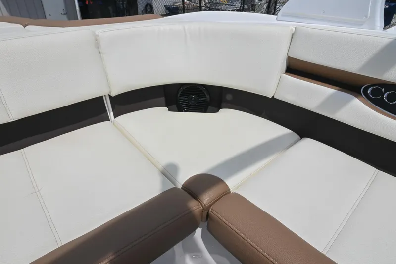 Slide: The Image of Luxurious seating in a 2022 Cobalt CS22 boat, featuring white and brown upholstery. - 23
