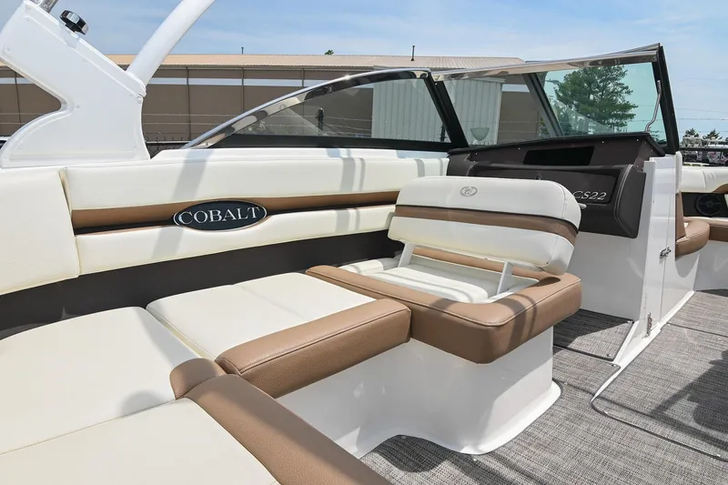 Slide: The Image of 2022 Cobalt CS22 boat interior with white and brown seating, showcasing luxury design. - 24