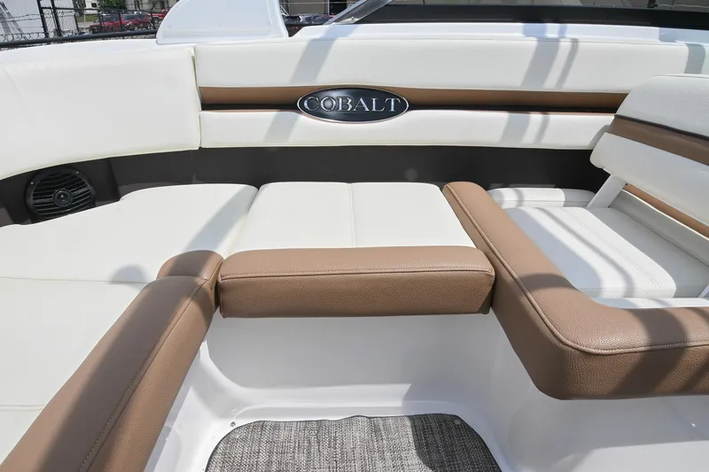 Slide: The Image of Interior seating of a 2022 Cobalt CS22 boat with brown and white upholstery. - 25