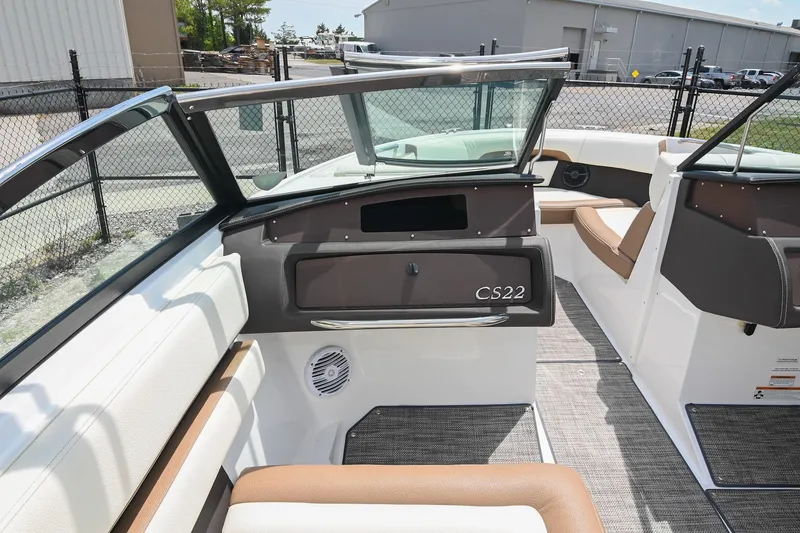 Slide: The Image of 2022 Cobalt CS22 boat interior with brown and white seating, open windshield, and modern design. - 29