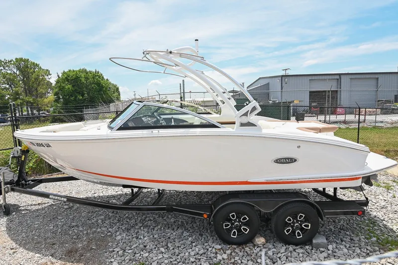 Slide: The Image of 2022 Cobalt CS22 boat on trailer, parked outdoors, under clear sky. - 3