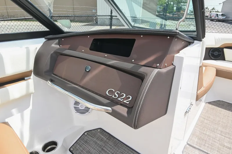 Slide: The Image of 2022 Cobalt CS22 boat interior with brown dashboard and modern design elements. - 30