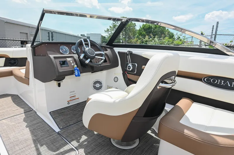 Slide: The Image of 2022 Cobalt CS22 boat interior with steering wheel, dashboard, and seating. - 32