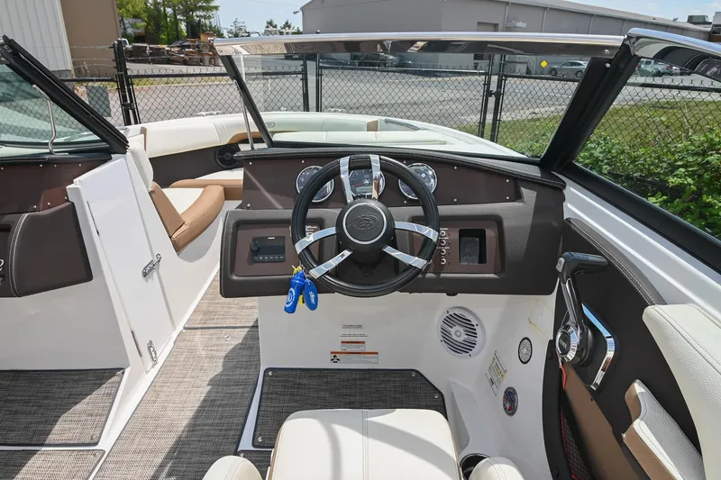 Slide: The Image of 2022 Cobalt CS22 boat interior with steering wheel and dashboard controls. - 33
