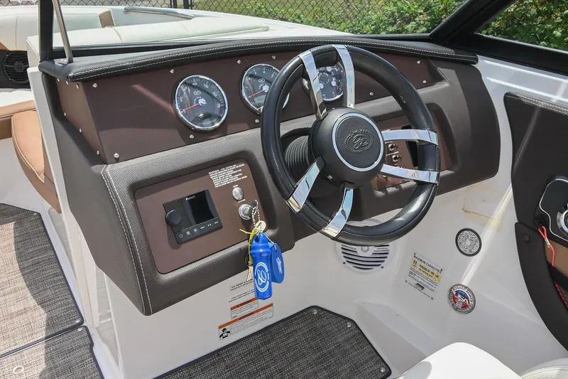 Slide: The Image of Steering wheel and dashboard of 2022 Cobalt CS22 boat, featuring modern gauges and controls. - 34
