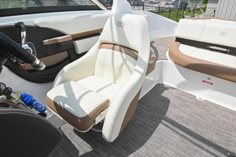Slide: The Image of 2022 Cobalt CS22 boat interior with white and brown seating, steering wheel, and modern design. - 35
