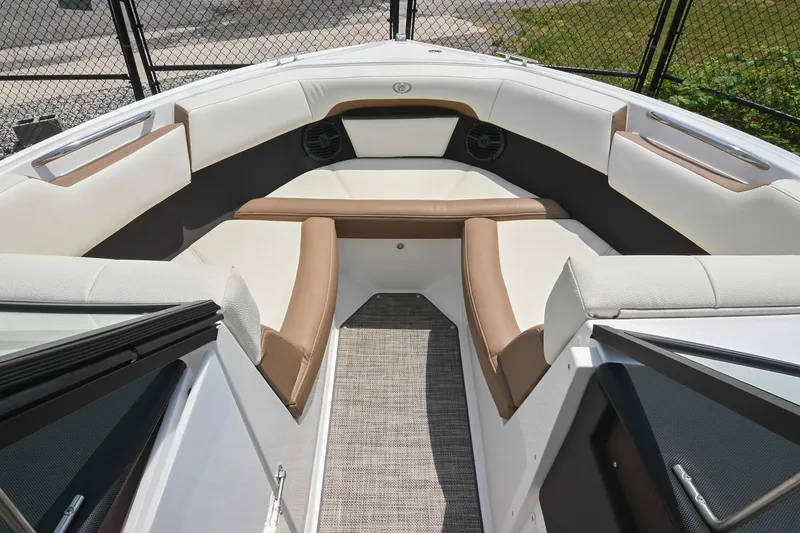 Slide: The Image of 2022 Cobalt CS22 boat interior with white and brown seating, open bow design. - 36