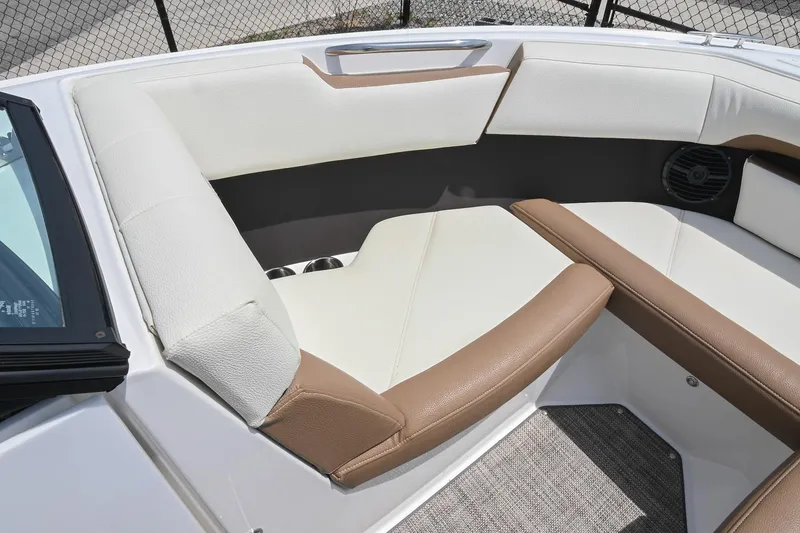 Slide: The Image of 2022 Cobalt CS22 boat interior with white and brown seating, cup holders, and speaker. - 37