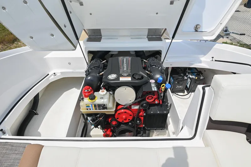 Slide: The Image of 2022 Cobalt CS22 boat engine compartment with open hatch, showcasing detailed engine components. - 42