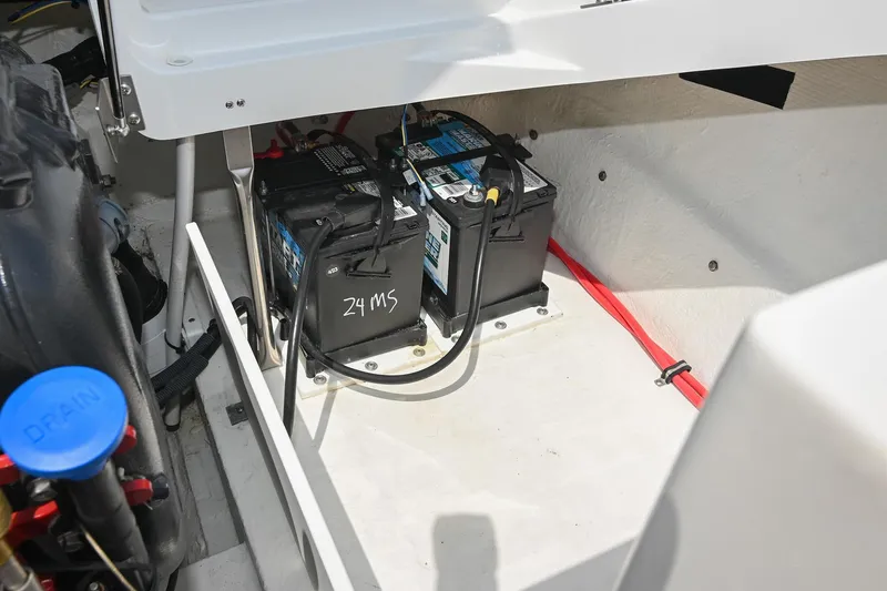 Slide: The Image of Battery compartment of a 2022 Cobalt CS22 boat, featuring dual batteries and wiring. - 45