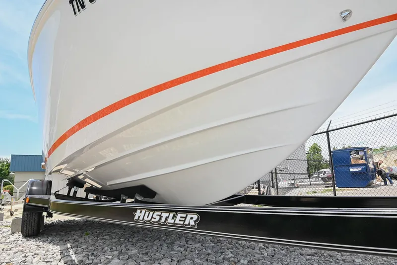 Slide: The Image of 2022 Cobalt CS22 boat on Hustler trailer, parked on gravel near a fence. - 49