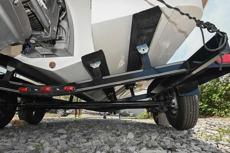 Slide: The Image of Underneath view of a 2022 Cobalt CS22 boat on a trailer, showcasing its hull and trailer structure. - 50