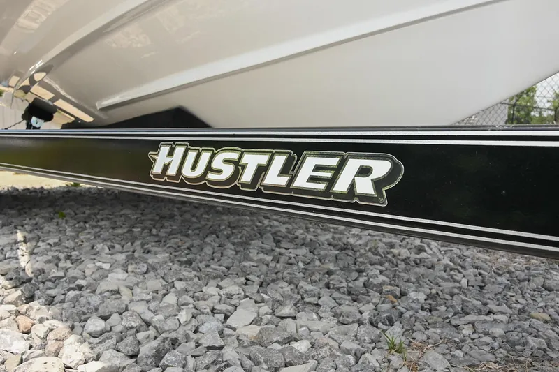 Slide: The Image of Trailer with "Hustler" branding under a 2022 Cobalt CS22 boat on gravel. - 51