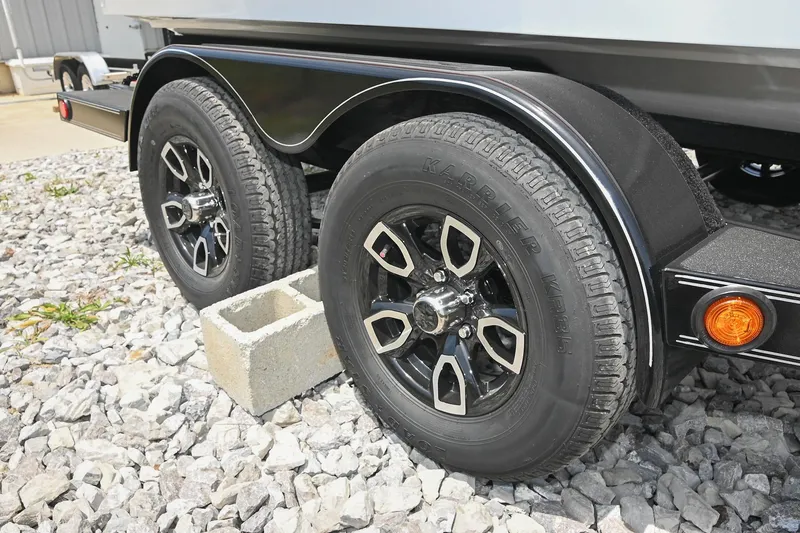 Slide: The Image of 2022 Cobalt CS22 trailer wheels on gravel with cinder block support. - 52