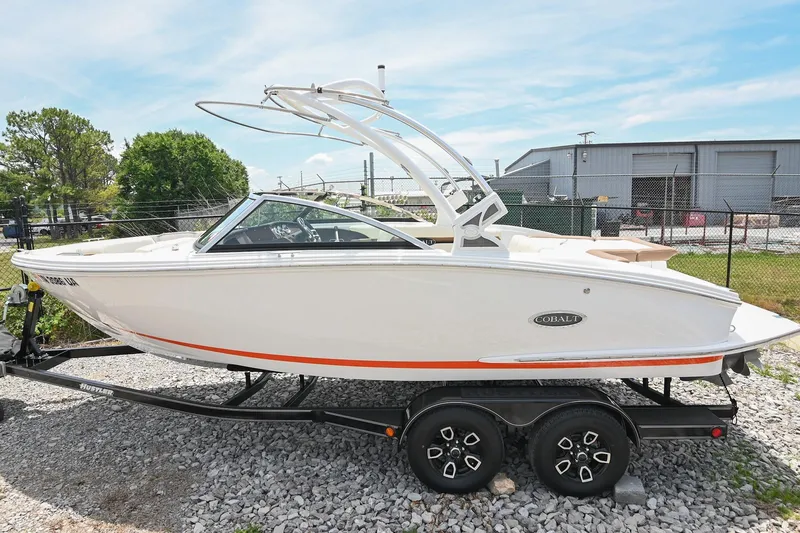 Slide: The Image of 2022 Cobalt CS22 boat on trailer, white exterior, parked outdoors. - 54