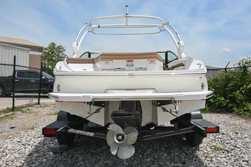 Slide: The Image of 2022 Cobalt CS22 boat on trailer, rear view, outdoors, sunny day. - 7