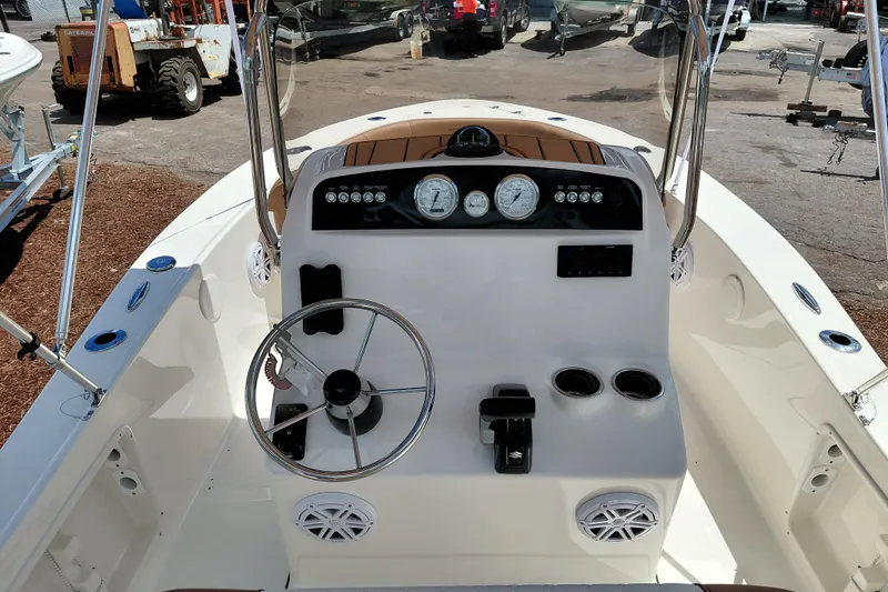 Slide: The Image of 2026 Pioneer 180 Islander boat dashboard with steering wheel and gauges. - 13