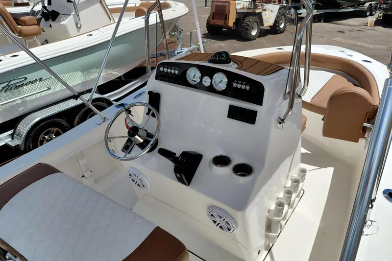 Slide: The Image of 2026 Pioneer 180 Islander boat interior with steering wheel and control panel. - 15