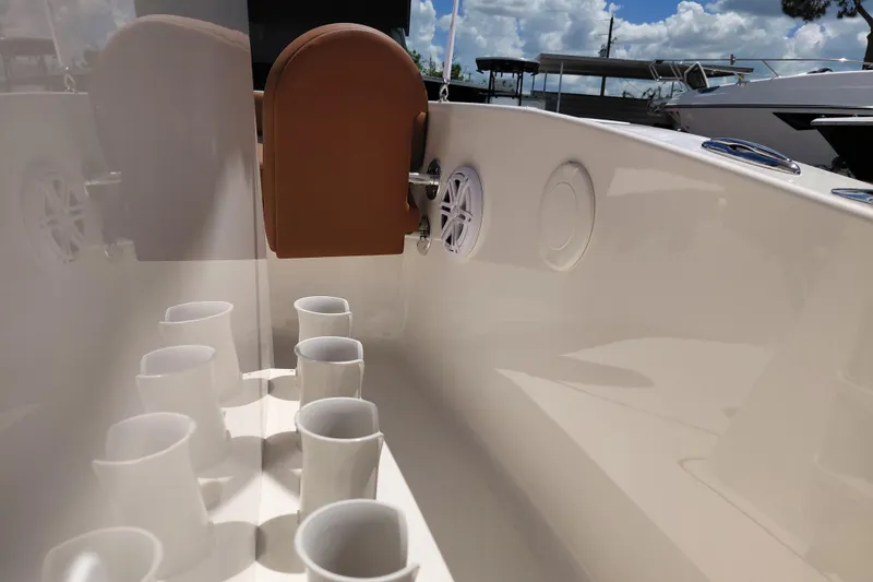 Slide: The Image of Interior of 2026 Pioneer 180 Islander boat with cup holders and speaker. - 16