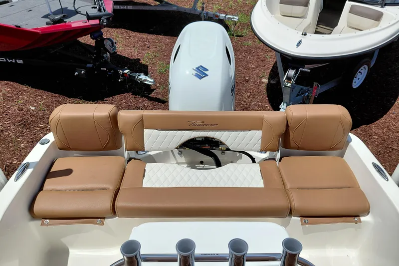 Slide: The Image of 2026 Pioneer 180 Islander boat with tan seating and Suzuki outboard motor. - 20
