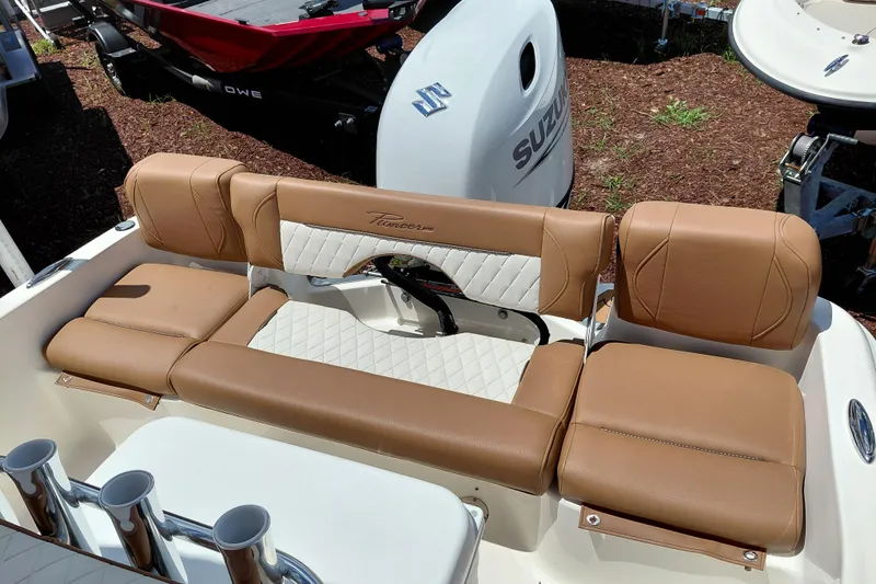 Slide: The Image of 2026 Pioneer 180 Islander boat with tan leather seating and rod holders. - 22
