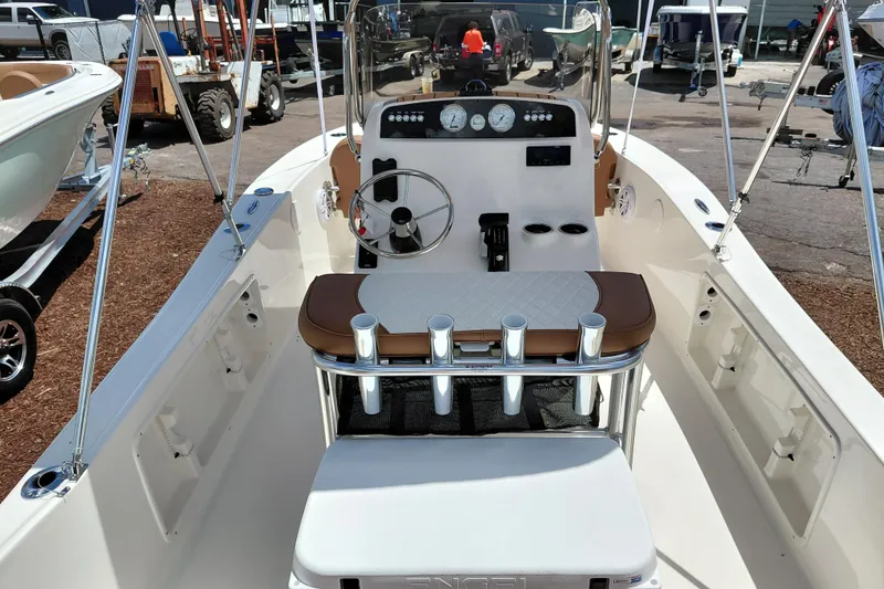 Slide: The Image of 2026 Pioneer 180 Islander boat interior with steering console and seating. - 24