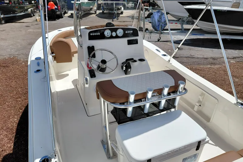 Slide: The Image of 2026 Pioneer 180 Islander boat interior with steering console and seating arrangement. - 25