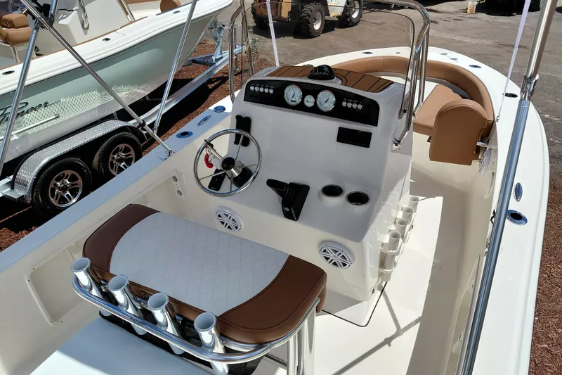 Slide: The Image of 2026 Pioneer 180 Islander boat interior with steering console and seating. - 26