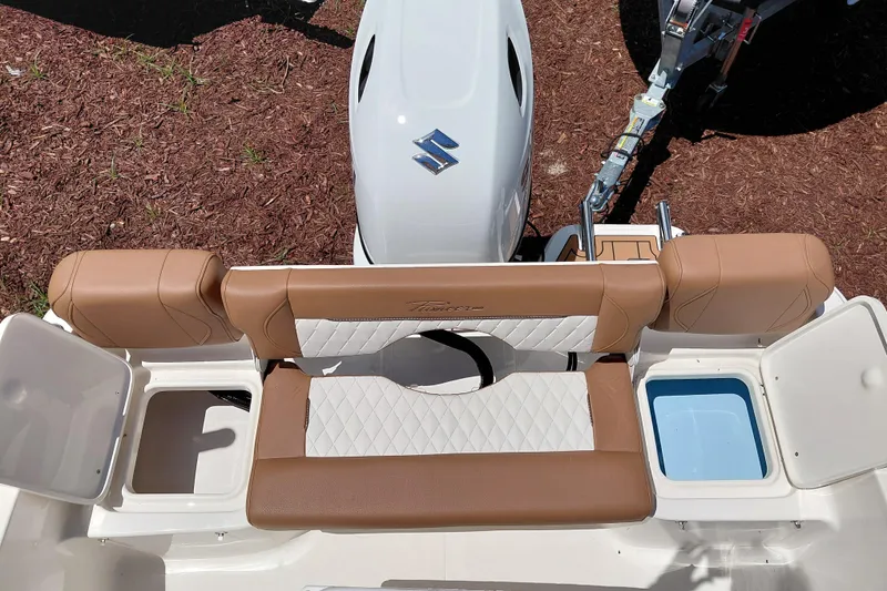 Slide: The Image of 2026 Pioneer 180 Islander boat interior with tan seating and Suzuki outboard motor. - 28