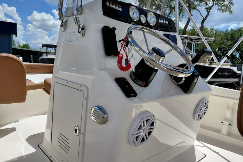 Slide: The Image of 2026 Pioneer 180 Islander boat console with steering wheel and controls. - 29