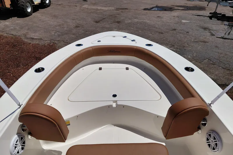 Slide: The Image of Bow seating area of 2026 Pioneer 180 Islander boat with tan cushions. - 31
