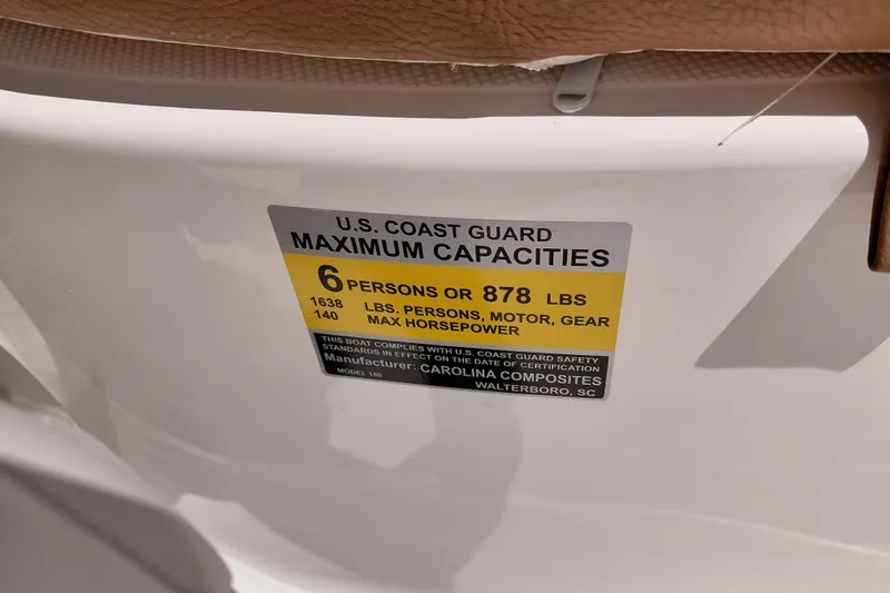Slide: The Image of U.S. Coast Guard capacity label on 2026 Pioneer 180 Islander boat, 6 persons or 878 lbs. - 34