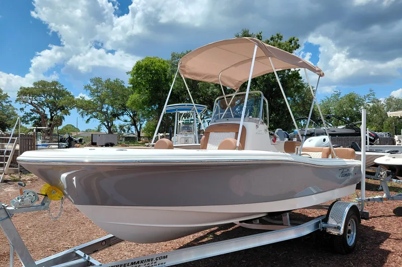Slide: The Image of 2026 Pioneer 180 Islander boat on trailer under a sunny sky. - 4