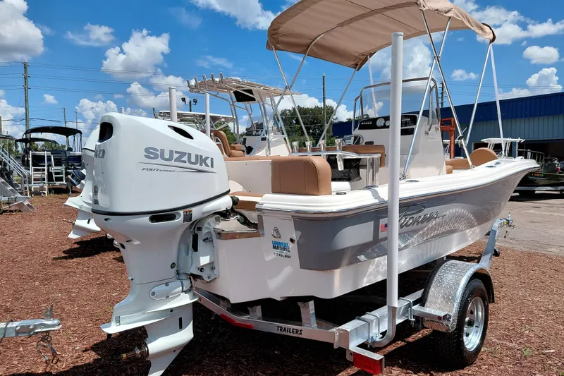 Slide: The Image of 2026 Pioneer 180 Islander boat with Suzuki engine on trailer, sunny day. - 7
