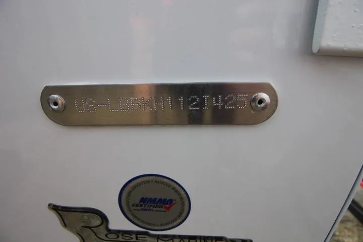Slide: The Image of 2025 Lund 1775 Impact XS Sport boat with identification plate and NMMA certification sticker. - 10